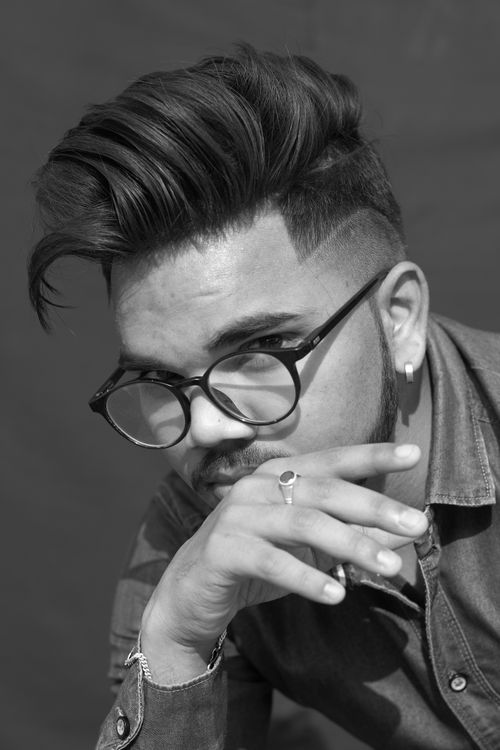Free Black and white portrait of a young man with eyeglasses and fashionable hairstyle. Stock Photo