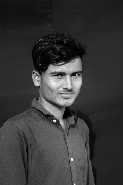 Free Grayscale portrait of an Asian man smiling in a polo shirt. Stock Photo