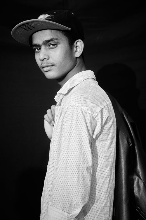 Free Black and white portrait of a young man in a cap looking over his shoulder. Stock Photo