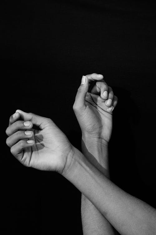 Grayscale Photo of Hands