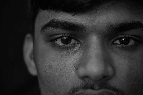 Free Detailed black and white close-up portrait highlighting eyes and facial features. Stock Photo