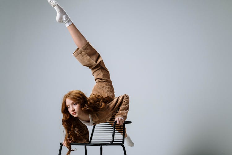 A Woman Dancing On The Chair