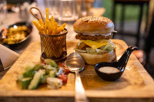 A Burger and Fries on a Wooden Board