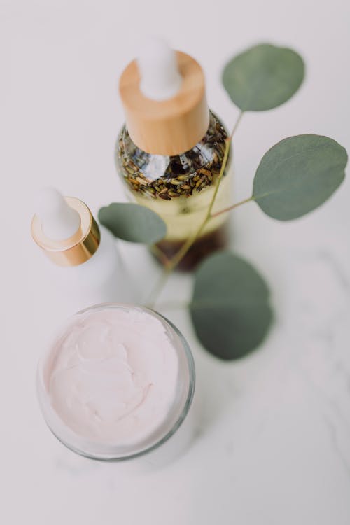 Free White and Brown Bottle on White Table Stock Photo