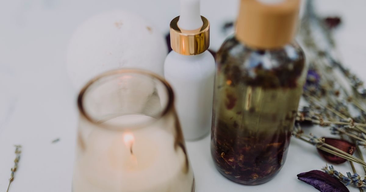 Wellness gift box with scented candle, bath salts, and dried lavender arranged on a wooden surface