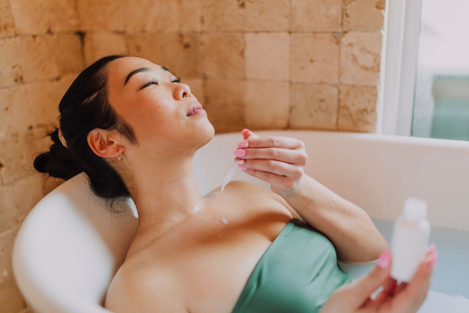 Woman enjoying a relaxing skincare routine in a bathtub, promoting self-care and wellness. - High Quality Performance Evaluation