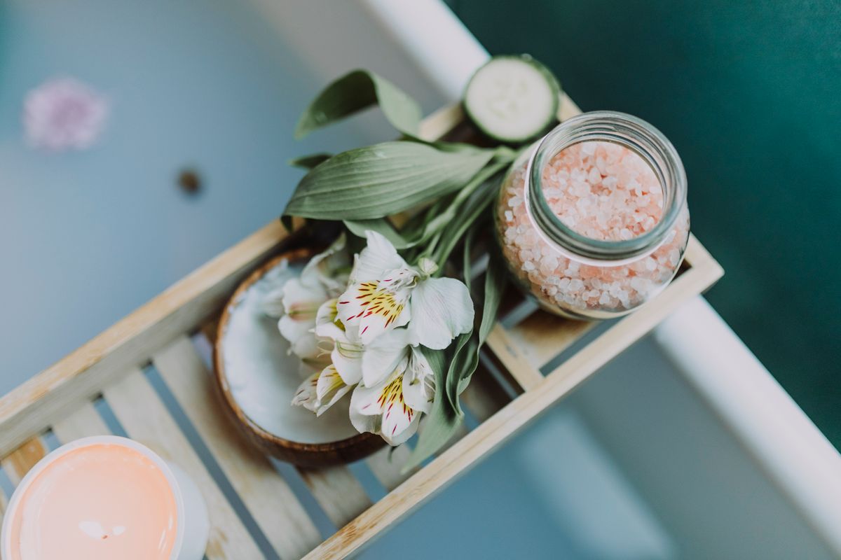 Spa essentials arranged on a tray for bathroom cabinet organization ideas