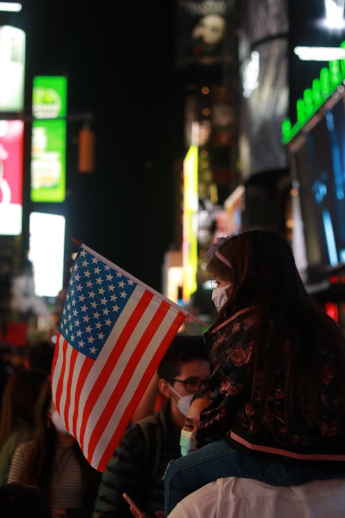 Child Piggybacking Holding American Flag