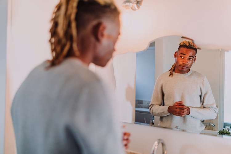 A Man Looking At Himself In The Mirror 