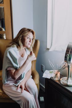 Woman relaxing in a cozy home spa with natural light, embracing self-care and tranquility.