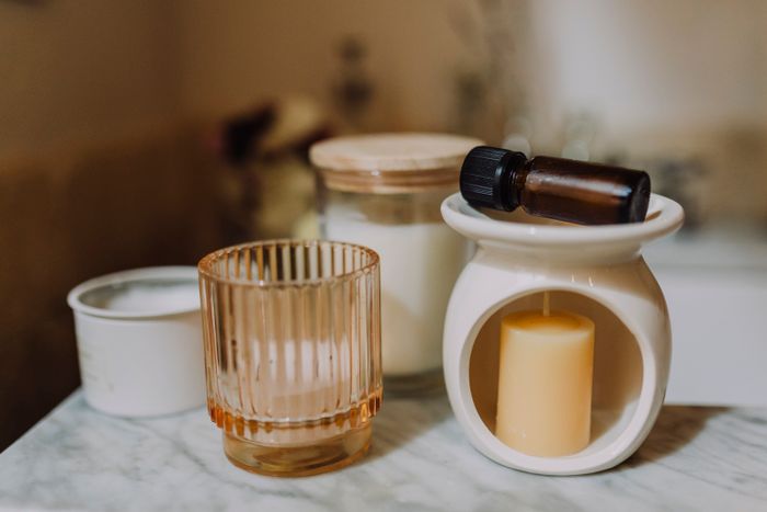 Wax, glass jars and oils on a marble bench