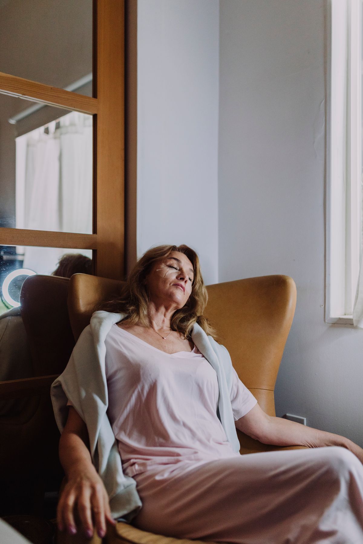 Person relaxing with eyes closed before a nap