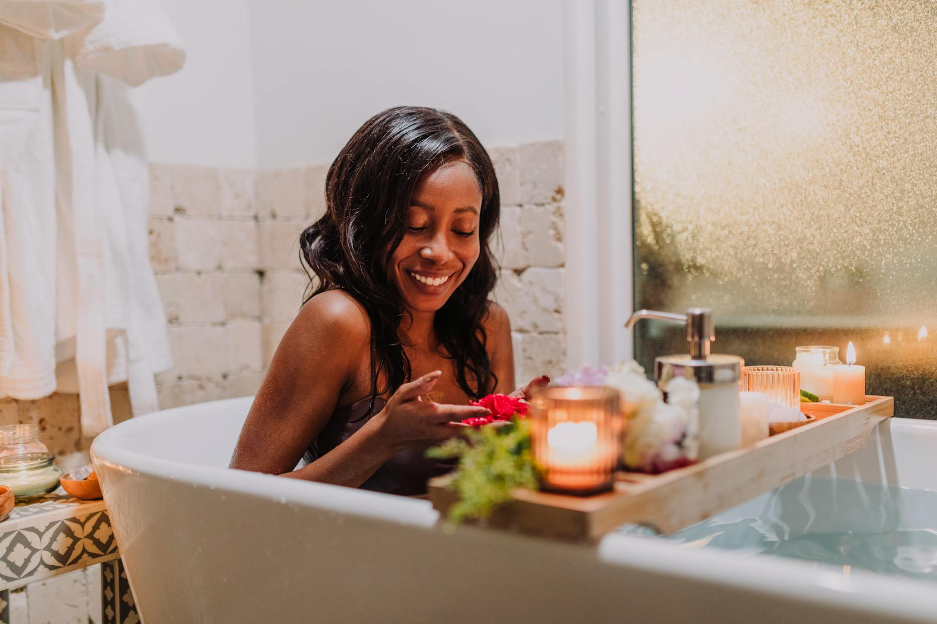 https://www.pexels.com/photo/a-woman-sitting-in-a-bathtub-with-a-wooden-tray-with-candlelights-6724544/