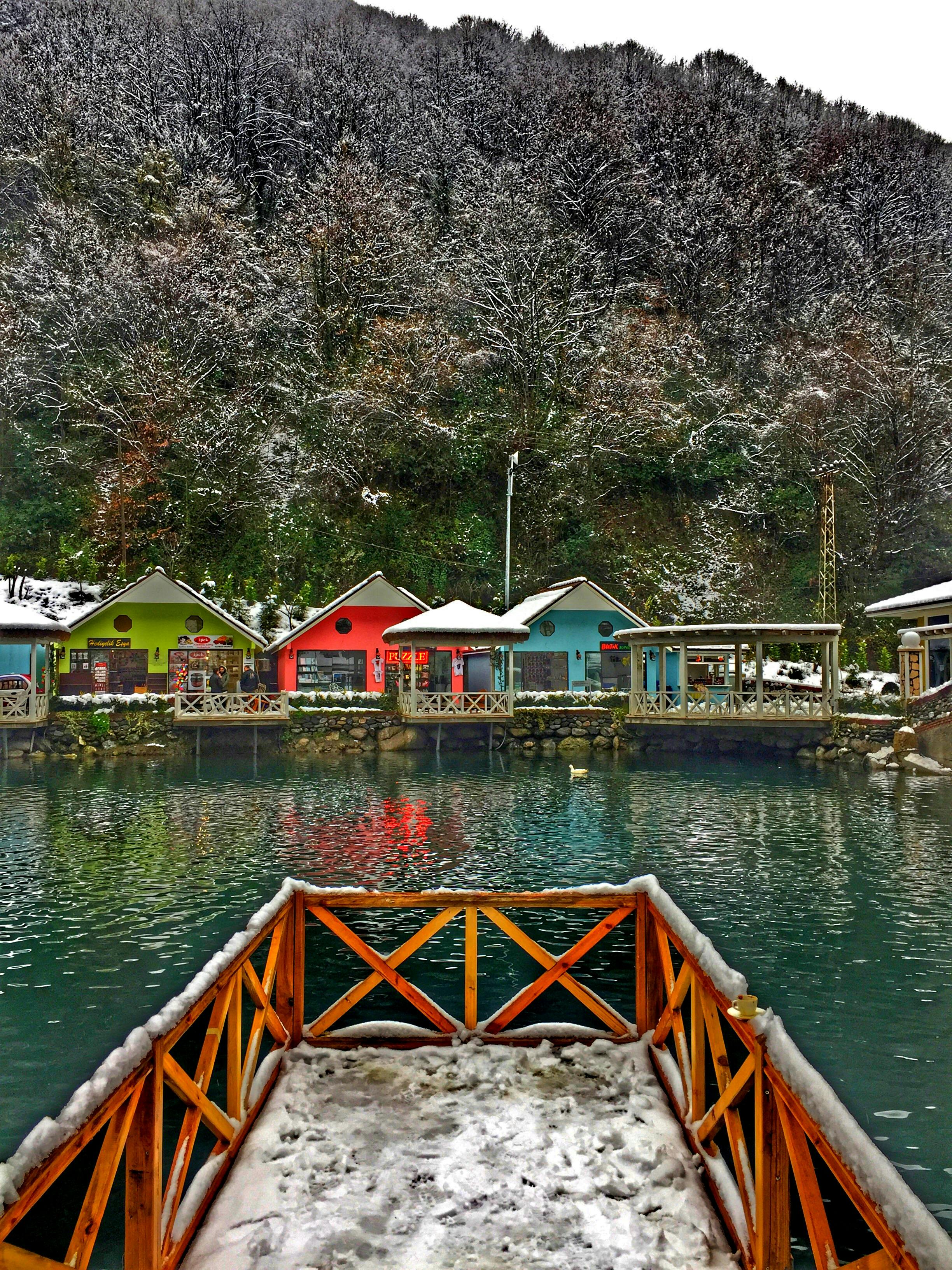土耳其萨潘卡的冬日宁静，白雪皑皑的湖面倒映着色彩缤纷、充满活力的房屋