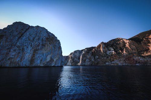 Scenic landscape of fjord against cloudless blue sky