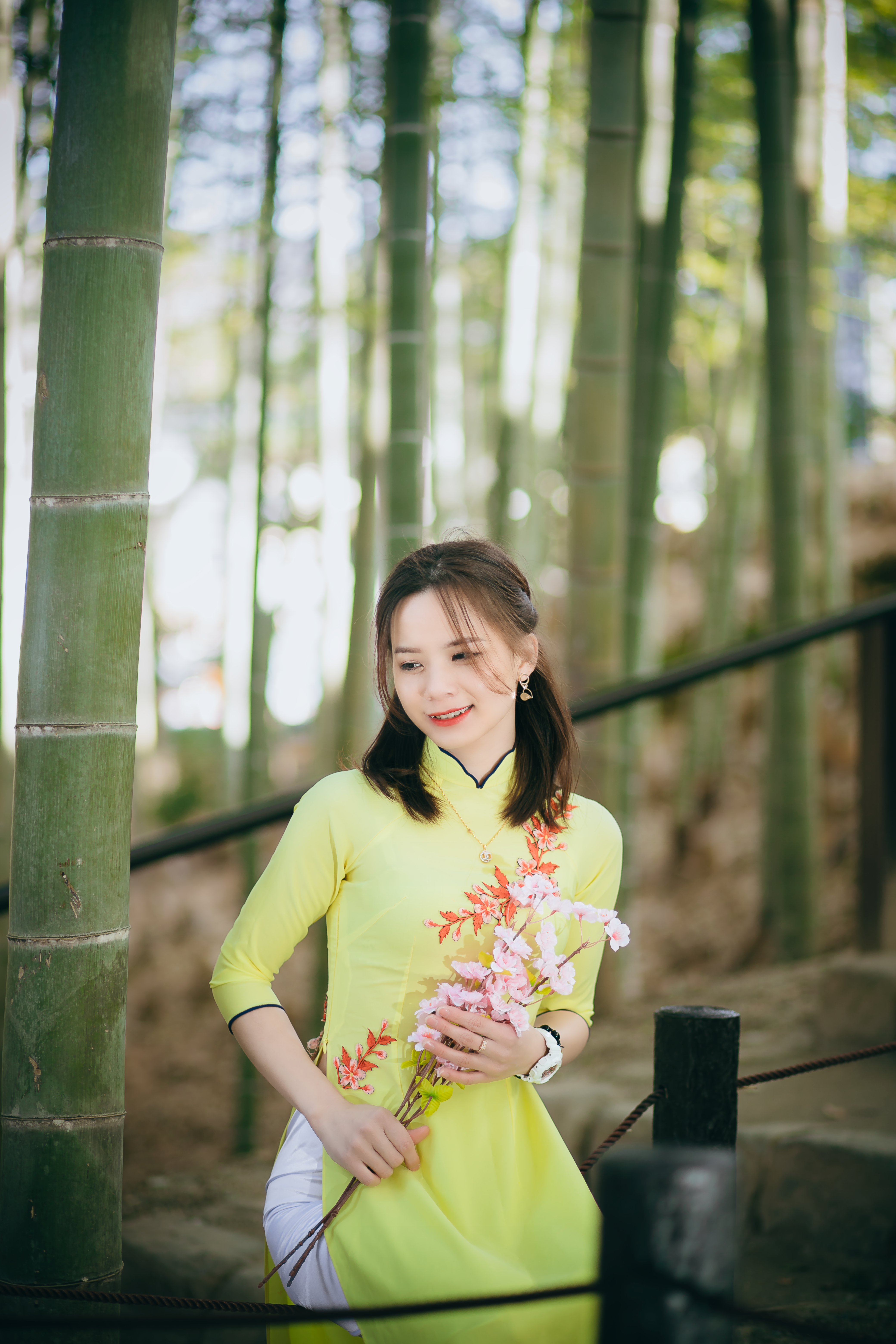 A Woman in Yellow Dress Sitting while Holding Flowers · Free Stock Photo