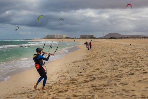 People Windsurfing in a Sea 