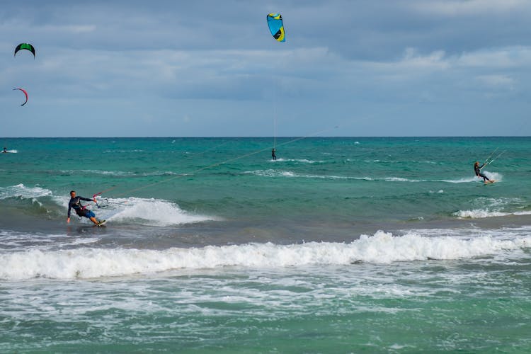 People Paragliding At The Beach