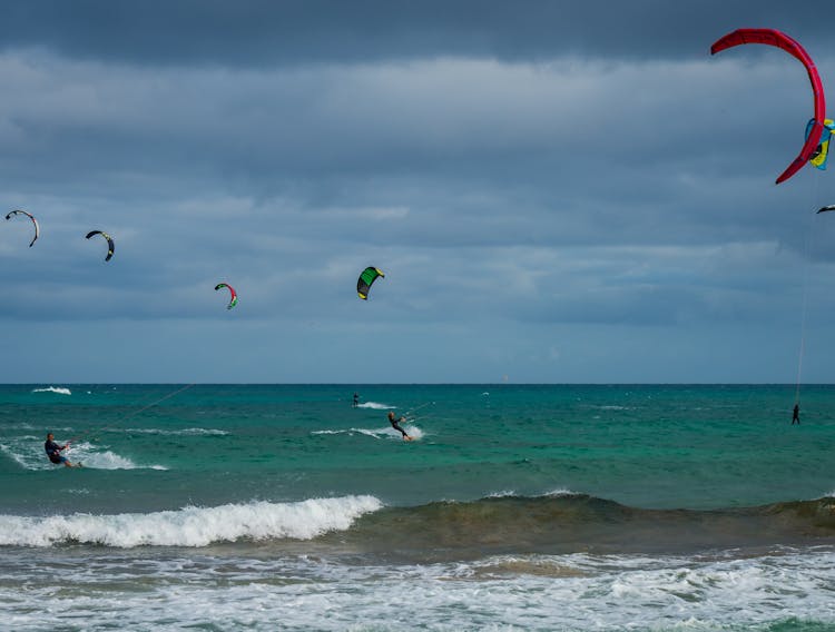 People Paragliding At The Beach