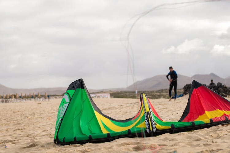 Man Playing With Large Kite On Bea