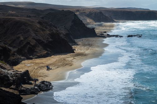 Free Stunning aerial view of Playa del Viejo Reyes with cliffs and crashing waves in Canary Islands. Stock Photo