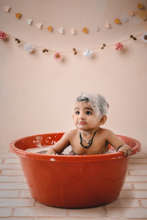 Free A Baby Boy Take a Bath on the Basin Stock Photo