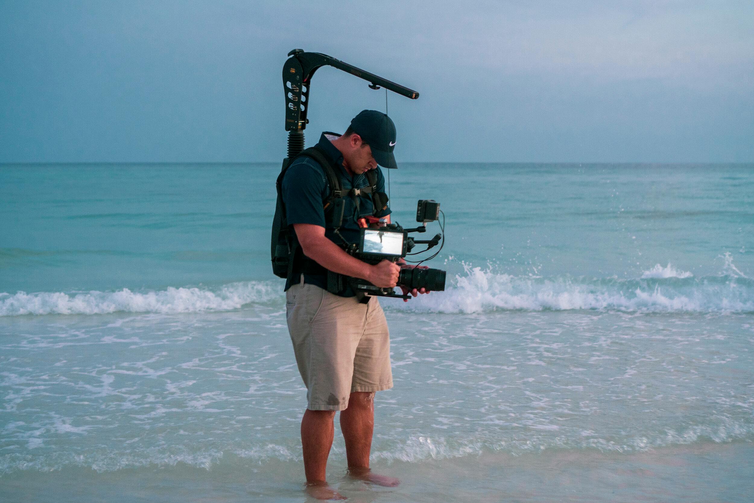 man making a film holding a camera