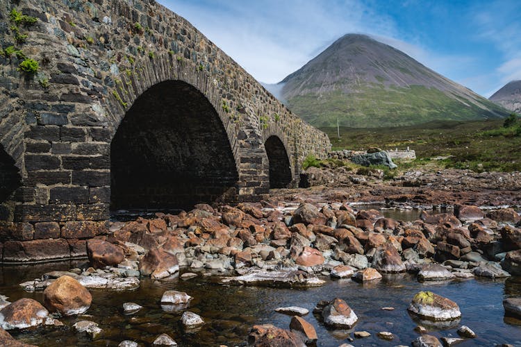 Stone Bridge With Volcano In Background