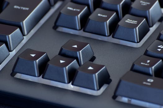 Detailed close-up of a black computer keyboard's arrow keys, highlighting the sleek design.