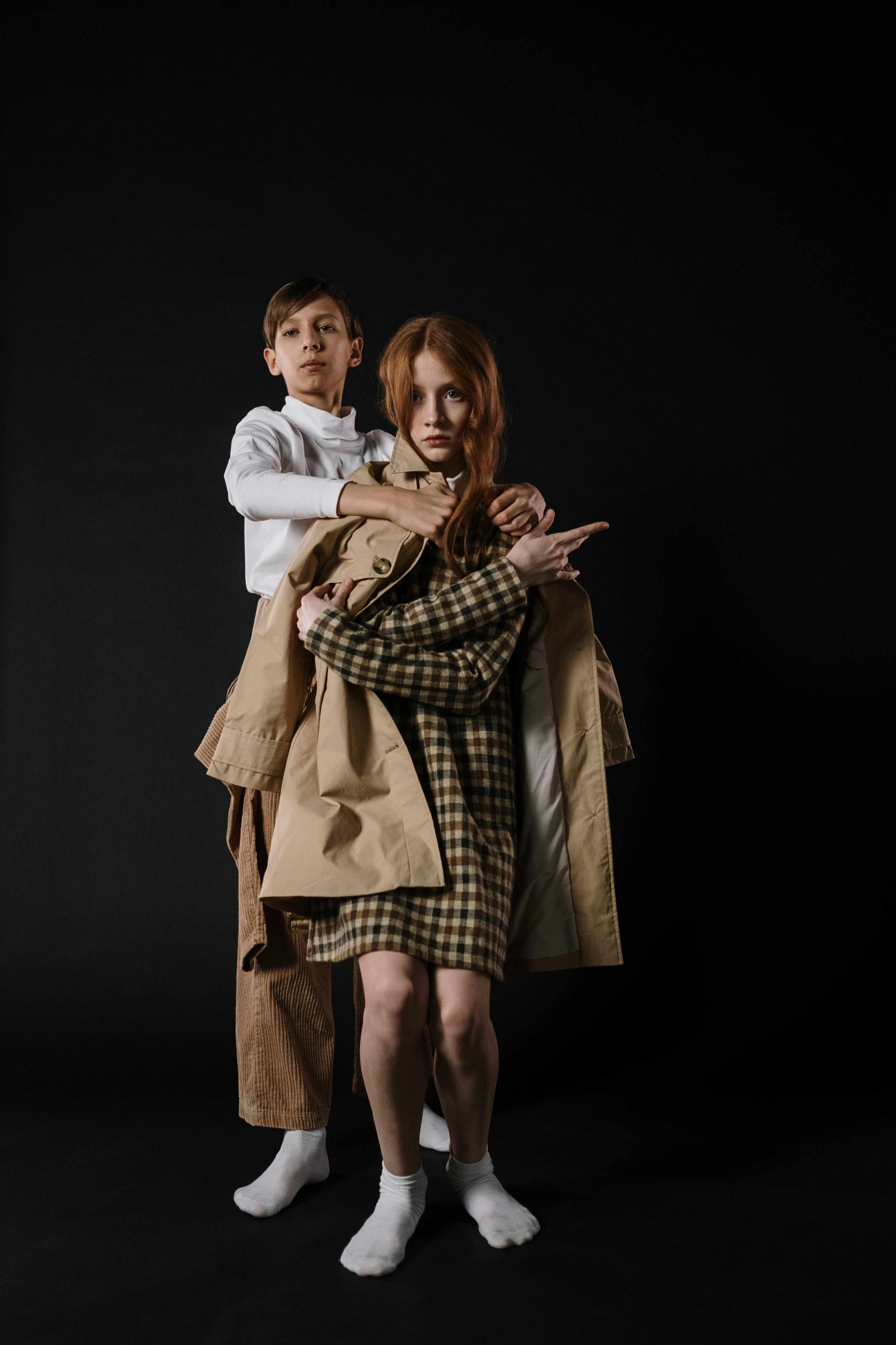 A Boy holding a Girl Posing Together · Free Stock Photo