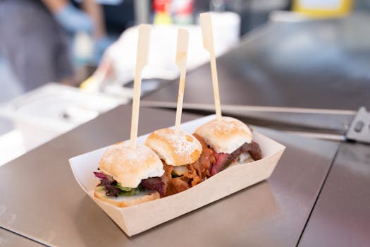 Appetizing mini burgers on skewers served in a paper tray, perfect for casual dining.