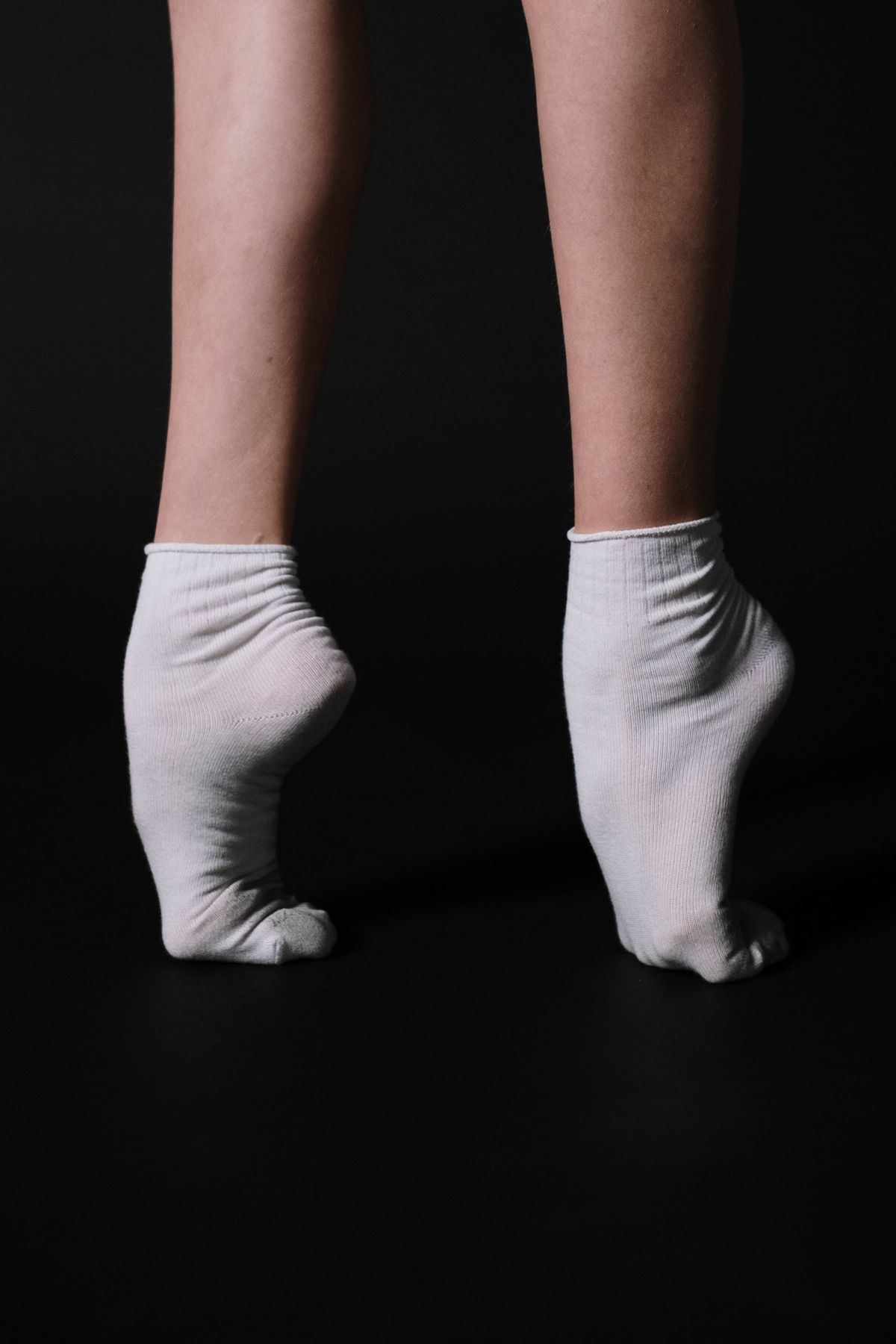 Close-up of white no show socks staying put on a wide foot Close-up of white no show socks staying put on a wide foot