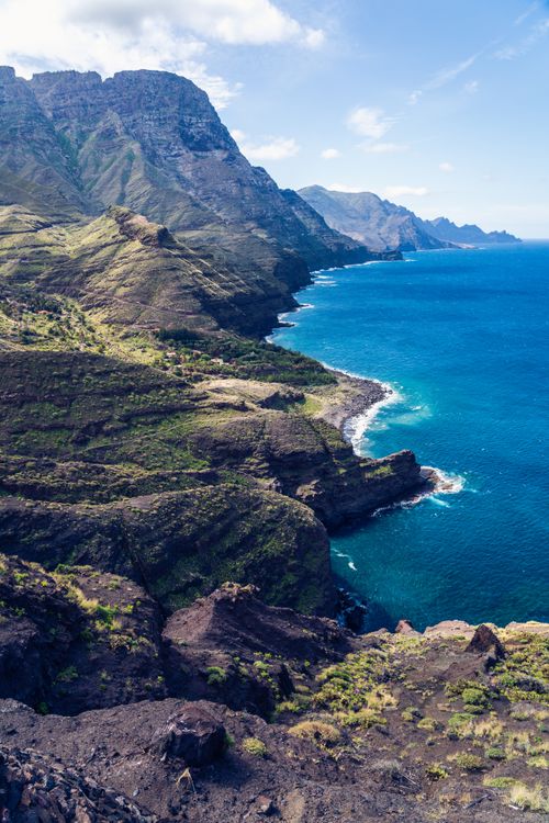 Free Stunning view of a mountainous coastline with blue sea under a clear sky. Stock Photo