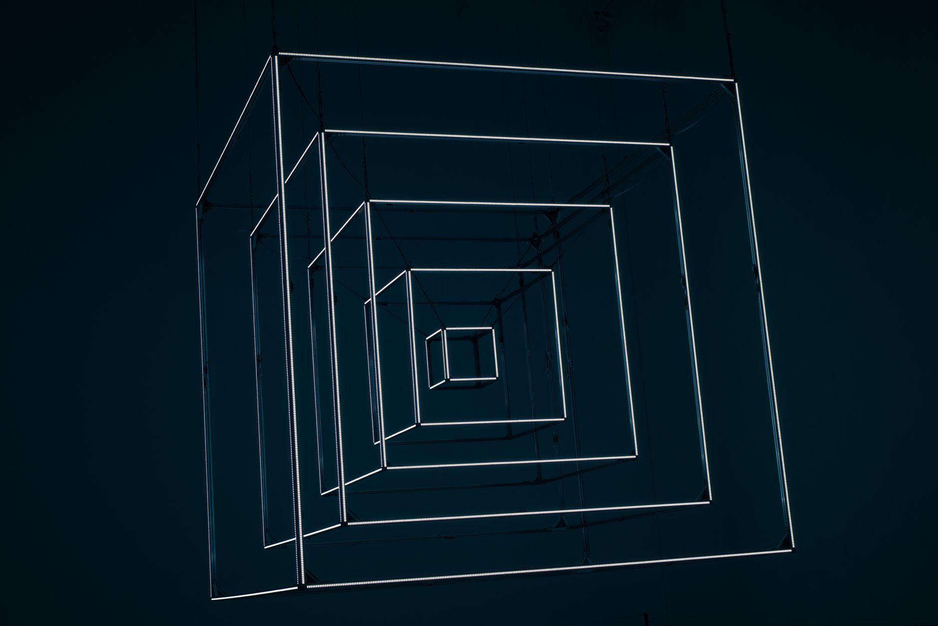 Dynamic abstract design with glowing neon cubes creating depth and perspective.