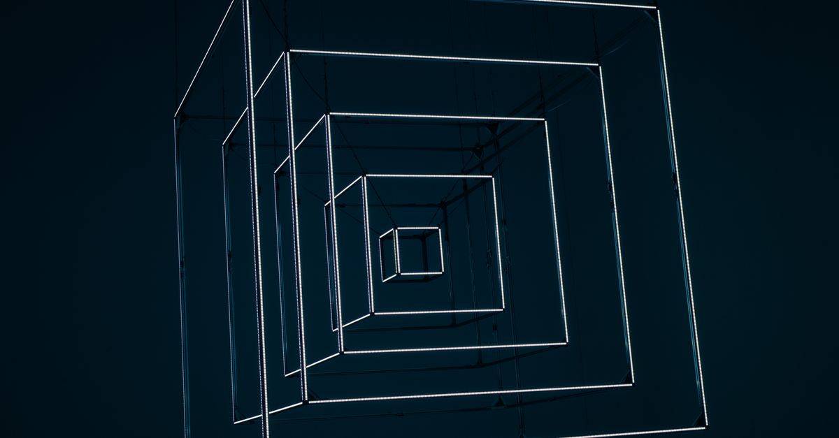 Abstract geometric metal cube installation with illuminated edges on a dark background.