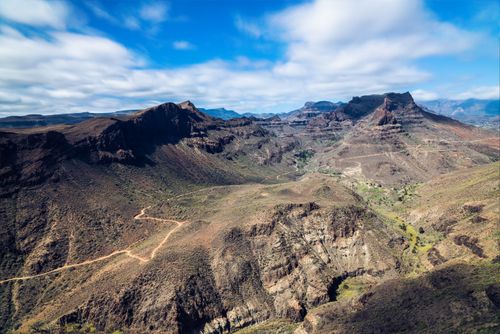 Free Stunning aerial view of a desert mountain range under a blue sky, showcasing natural beauty. Stock Photo