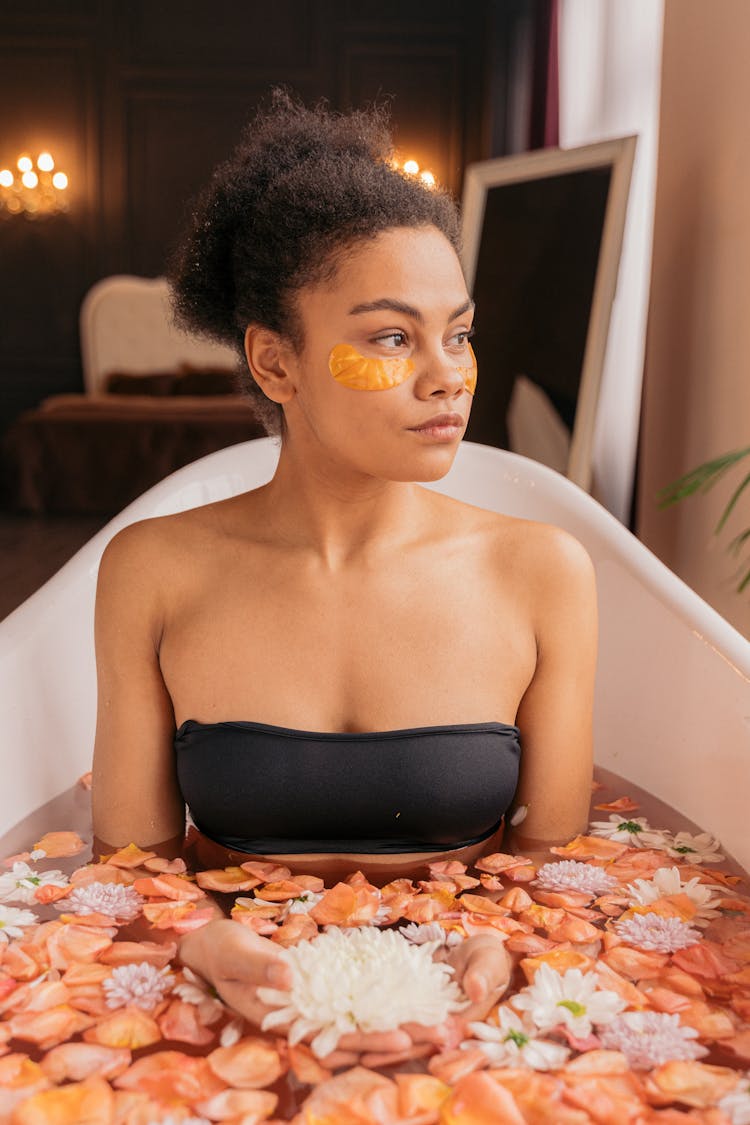 Woman Relaxing In A Flower Bath