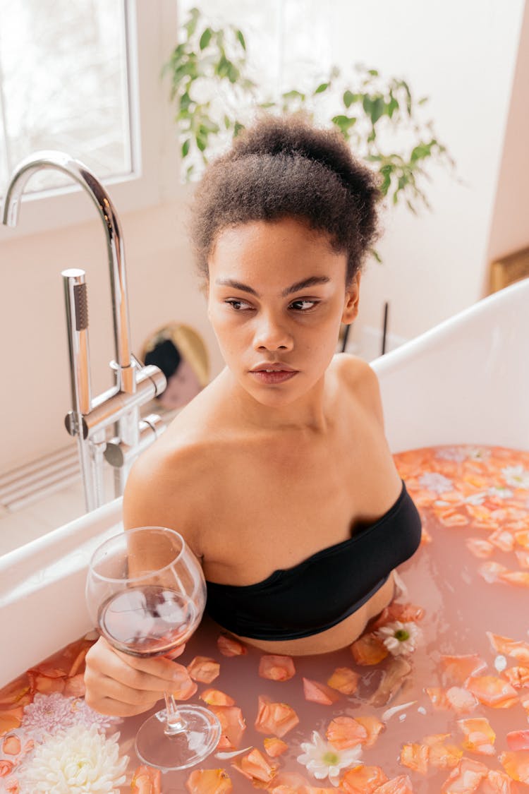 Woman Relaxing In A Flower Bath