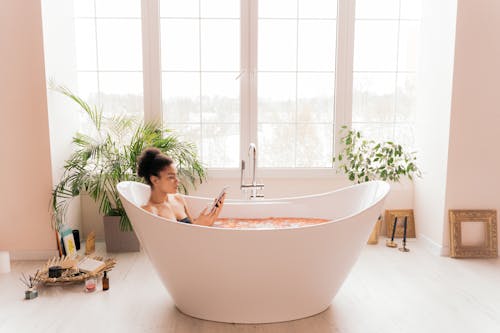 A Woman Sitting on the Bathtub
