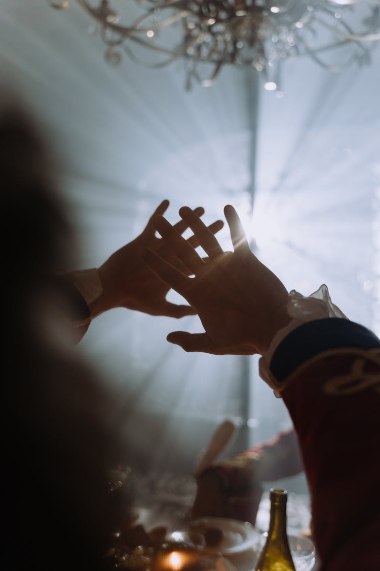 A Person Blocking The Light With Hands