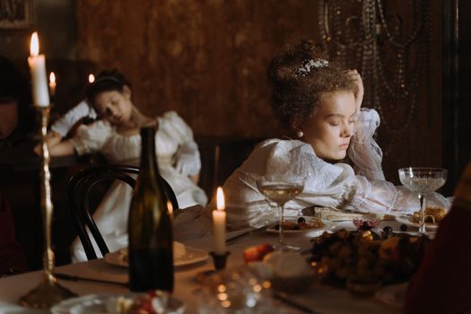 Man and Woman Sitting on Chair in Front of Table With Candles