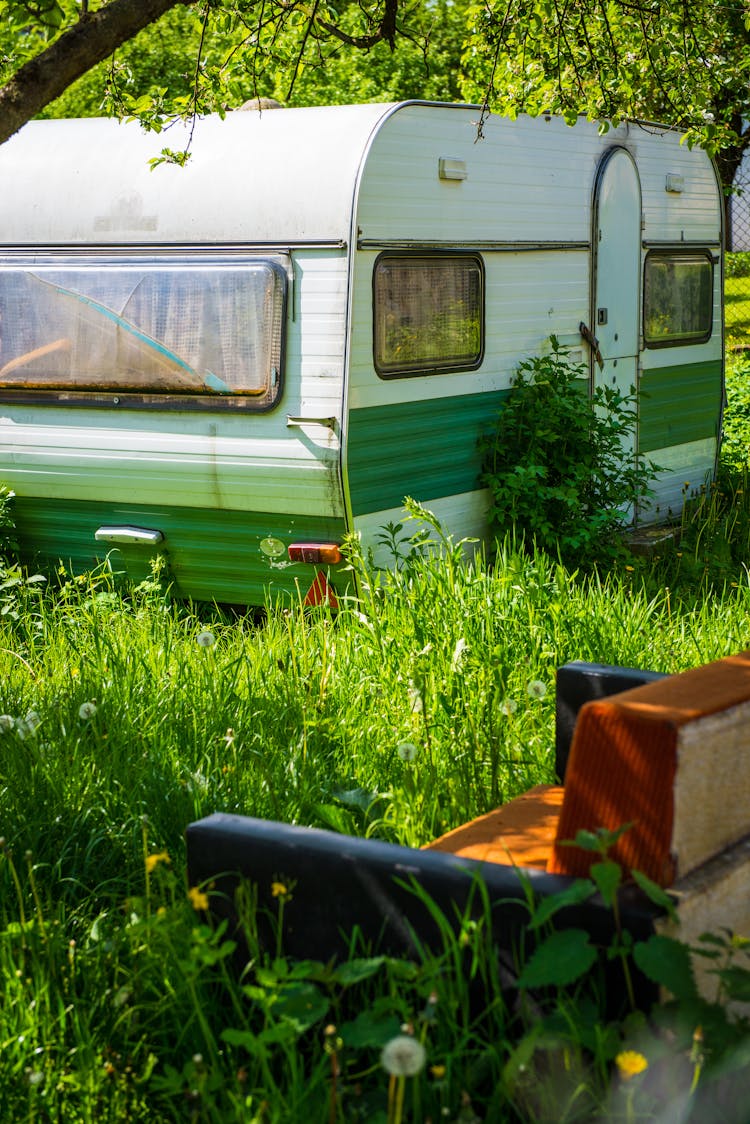 Camper Trailer Parked In Green Grass