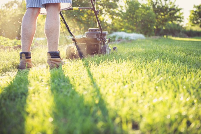 Landscaper operating a mower on a residential property