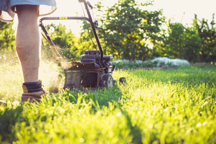Landscaping crew mowing a residential lawn