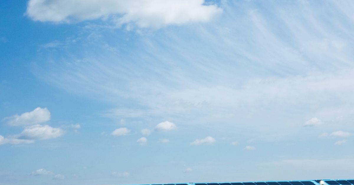 Photo by Magic K Solar panels under a clear blue sky, symbolizing renewable energy and sustainability.