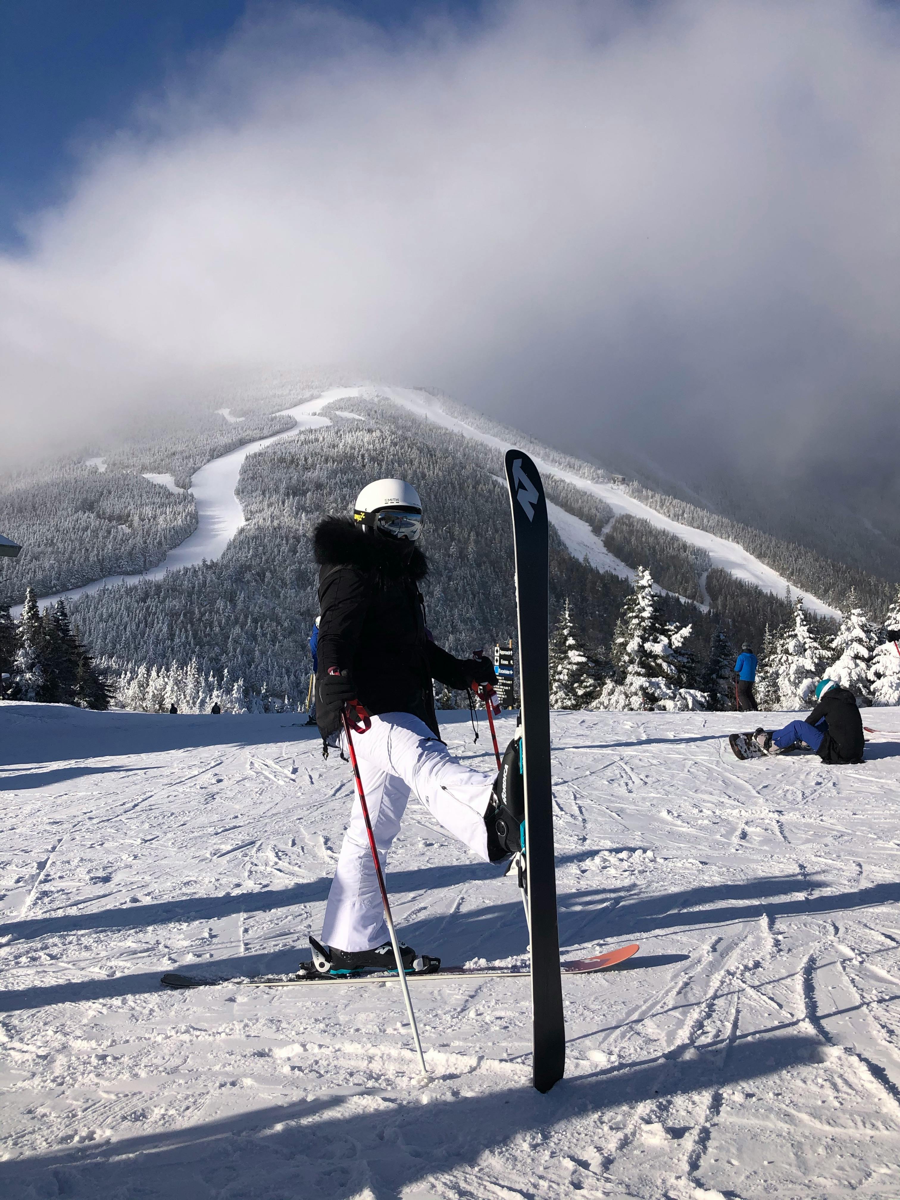 unrecognizable skier standing on snowy slope