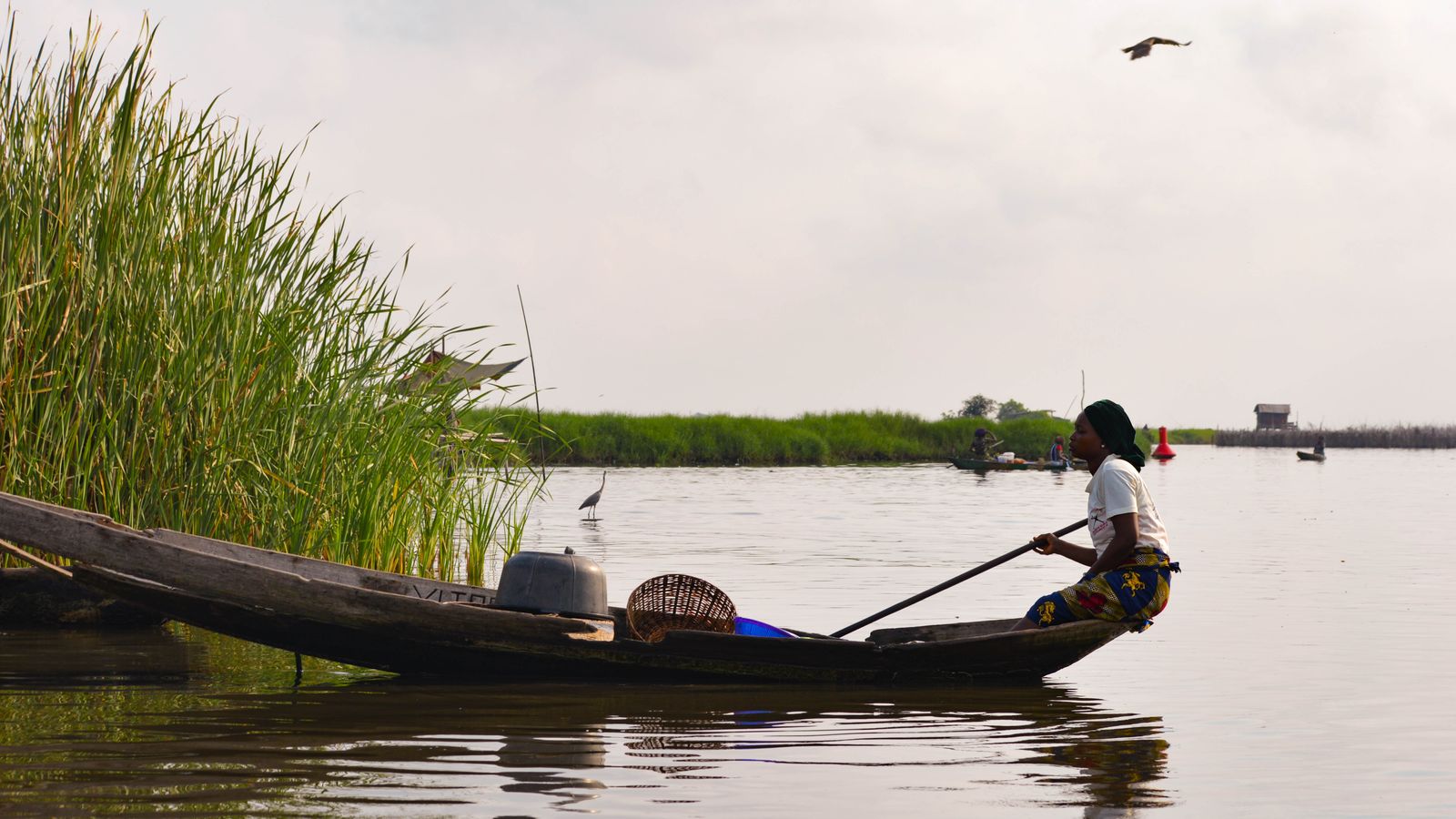 A woman riding a boat, Benin