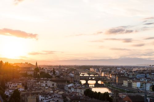 Free Captivating view of Florence skyline with iconic bridges and a stunning sunset. Stock Photo