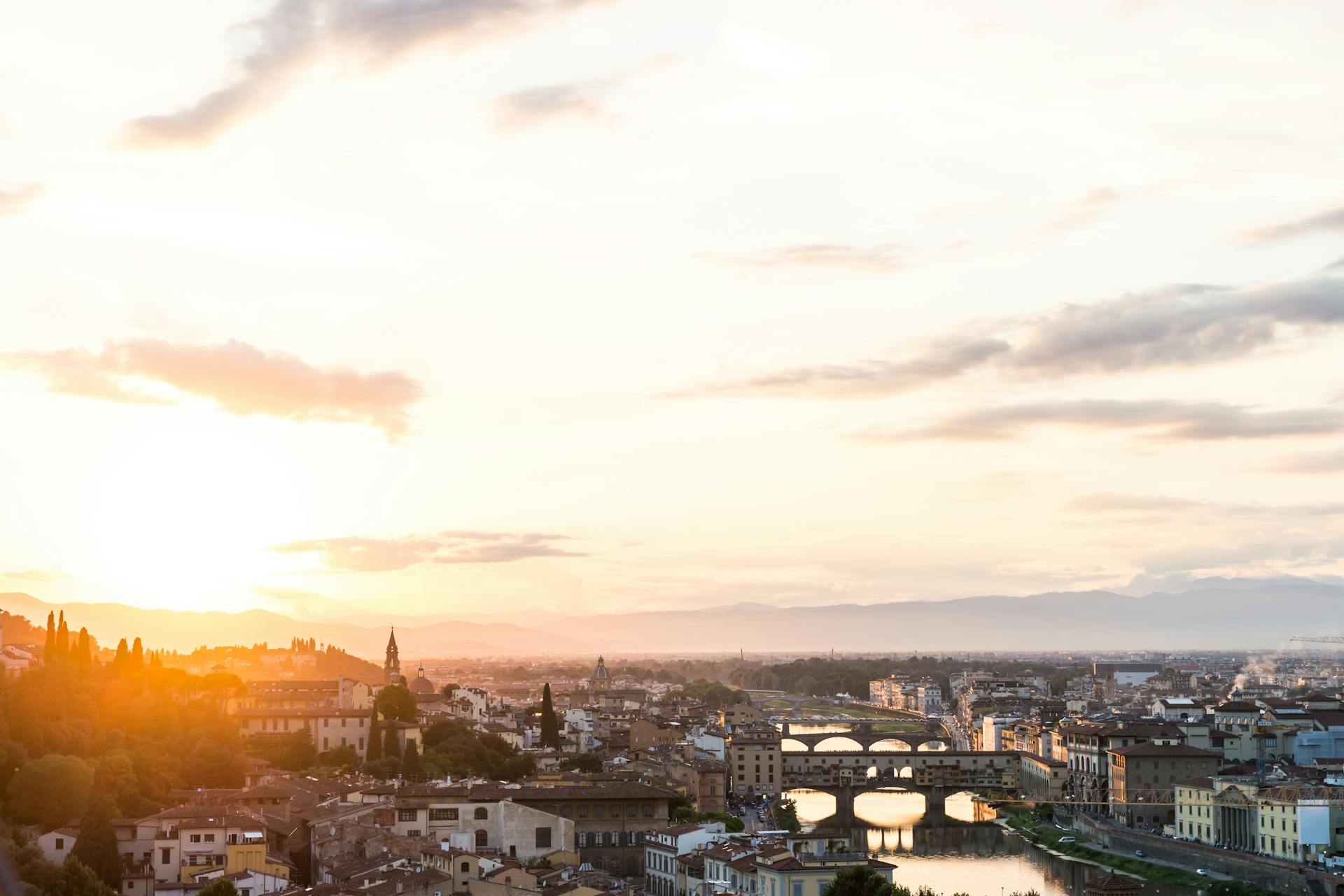 Beautiful view of Florence skyline with iconic bridges and sunrise lighting.