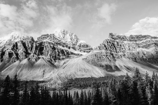 Monochrome image of snow-capped rocky mountains with dramatic scenery.